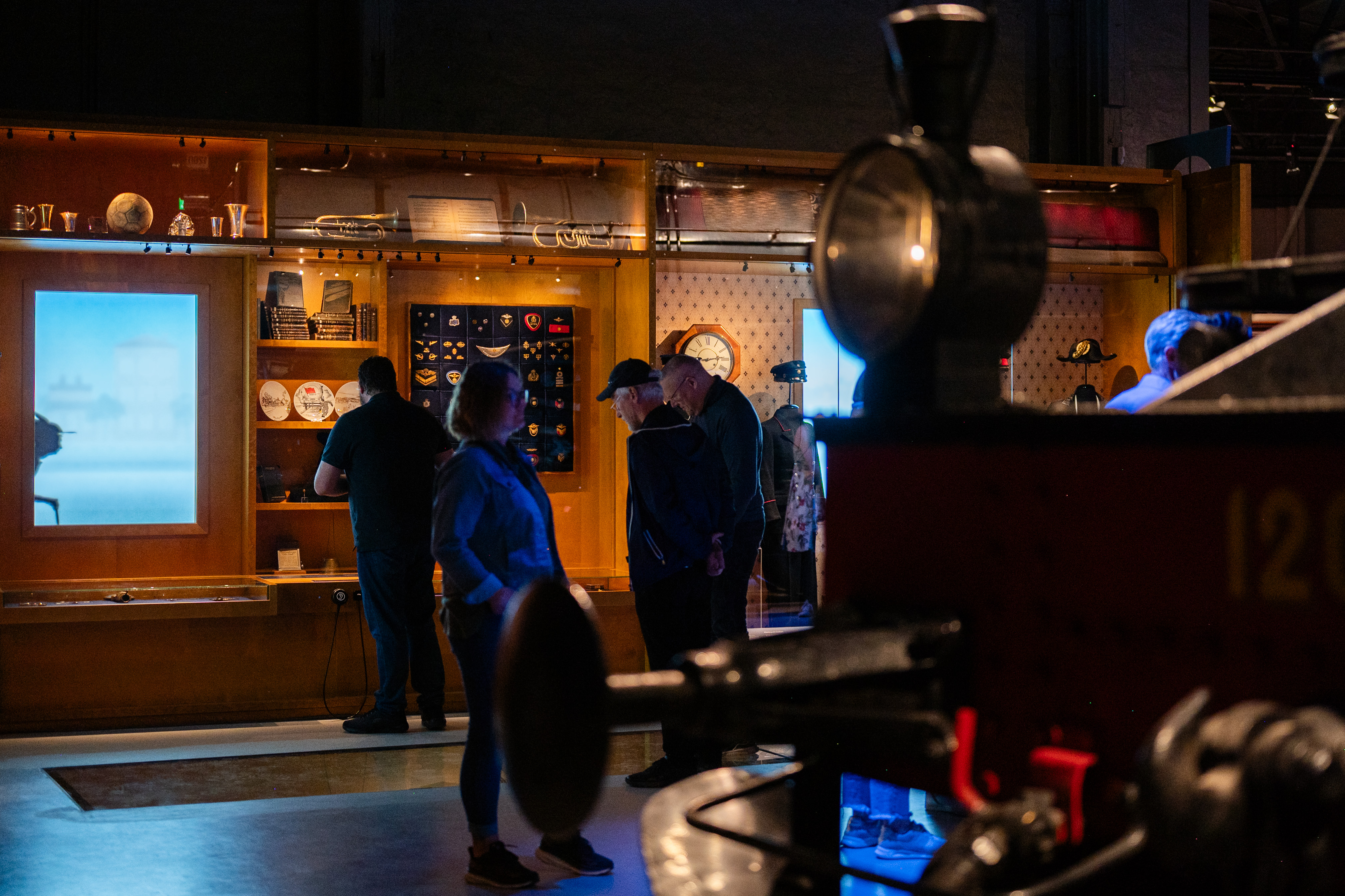 a gruop of people looking at an exhibition