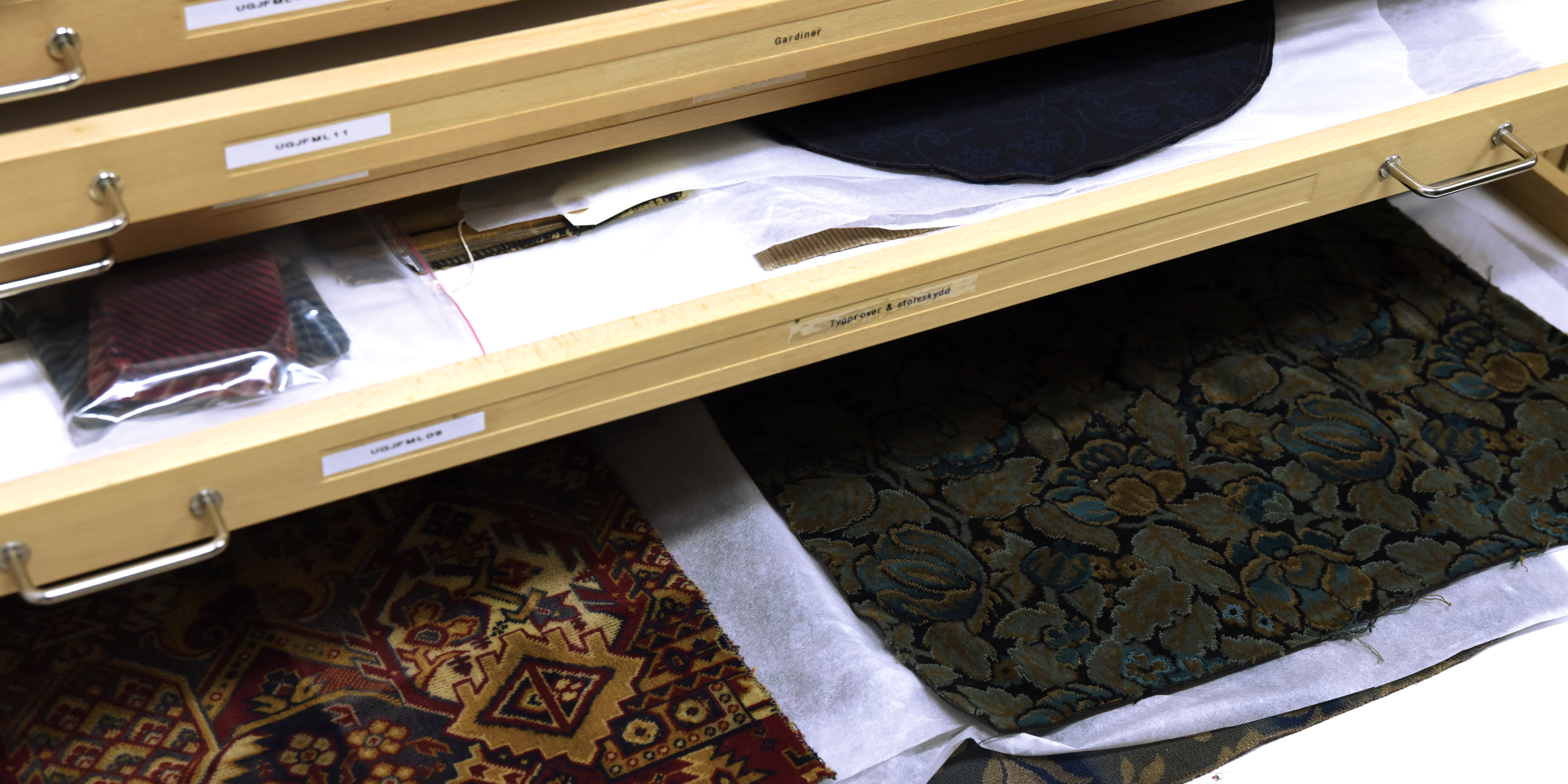 A close-up of old textiles stored in boxes.