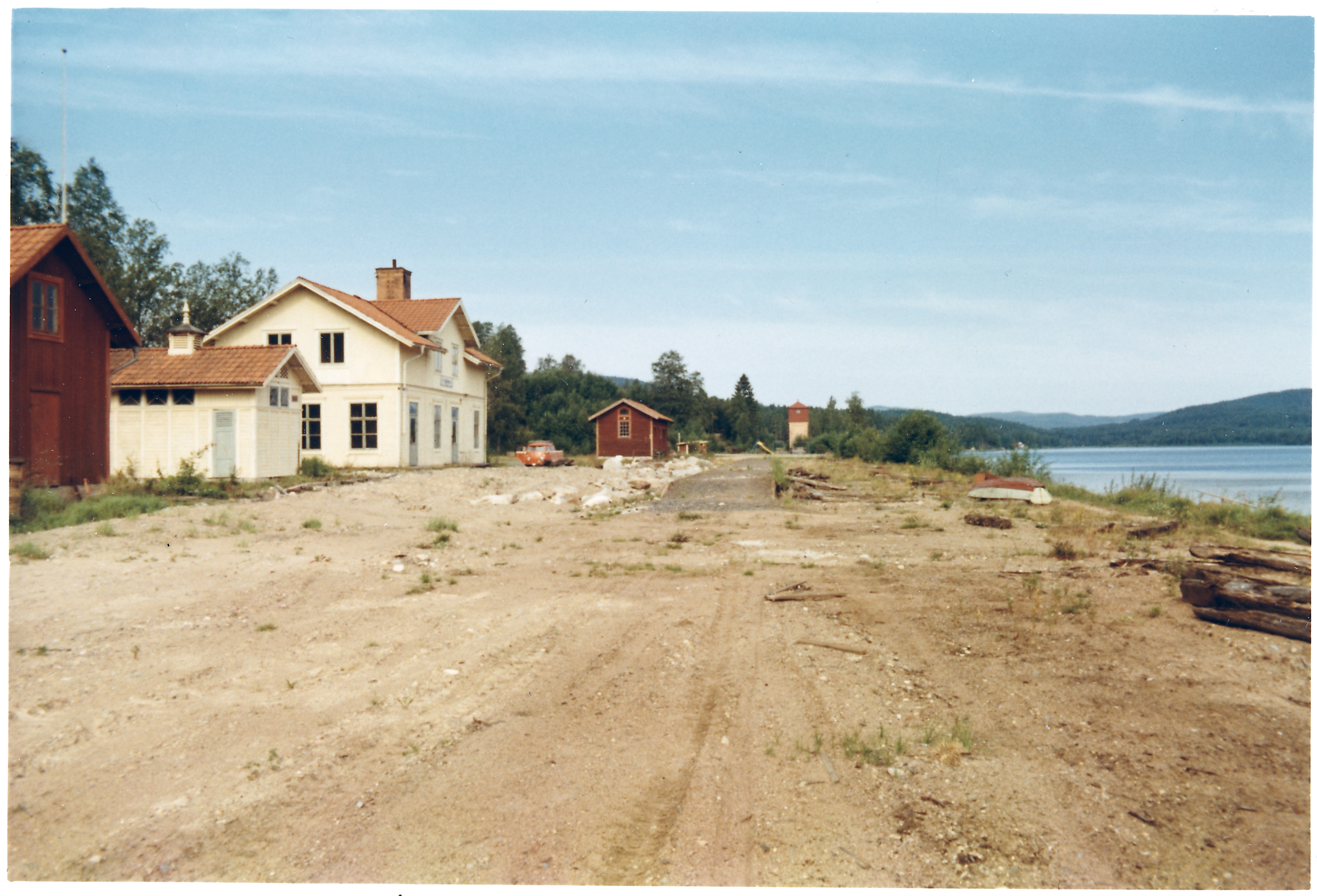 White station building with surrounding buildings without railway tracks. White station building with surrounding buildings without railway tracks. Sågmyra railway station, the station is closed and the tracks are torn up