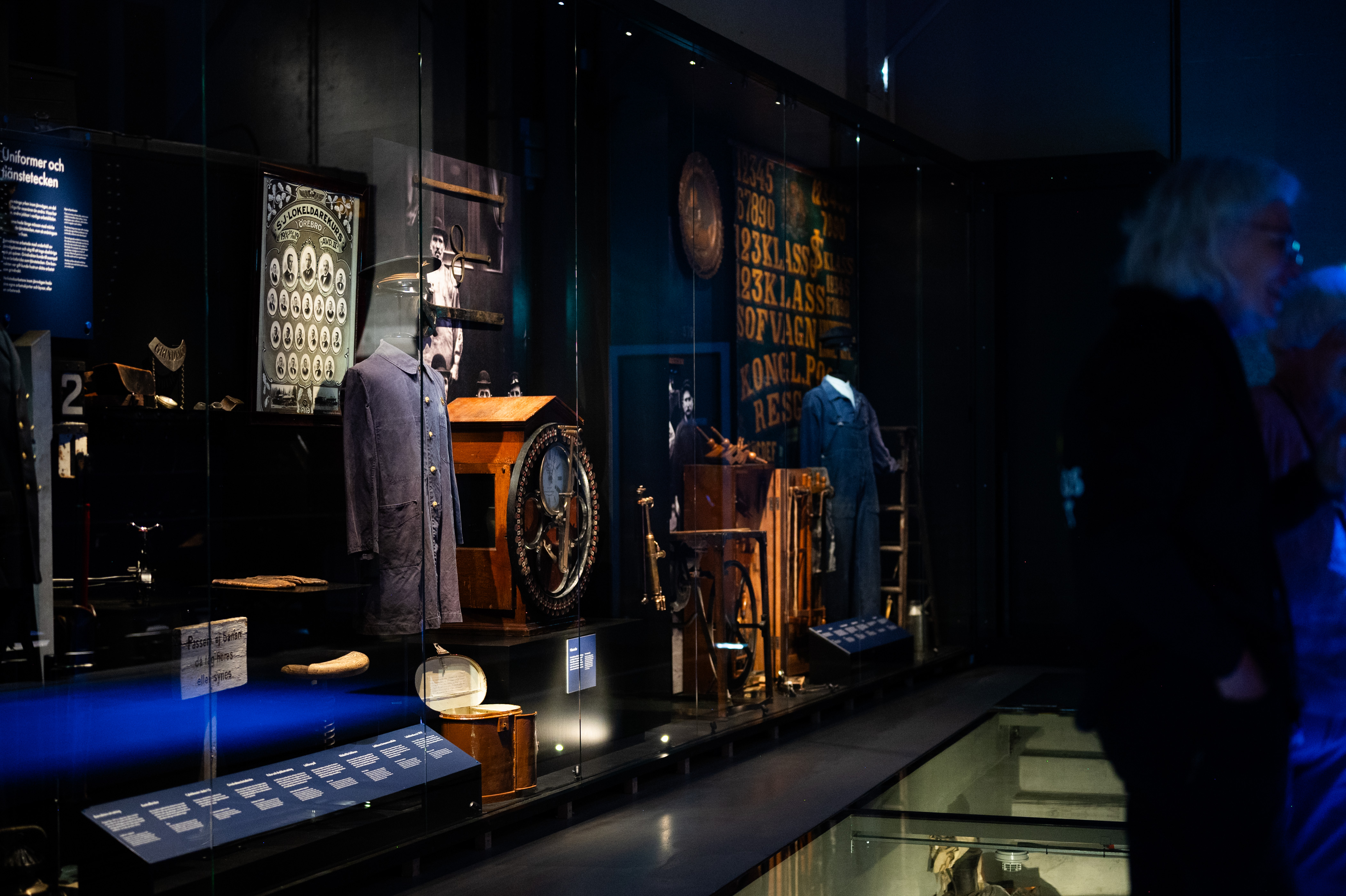 Rail road related objects are on display, you can see working clothes and a big watch.